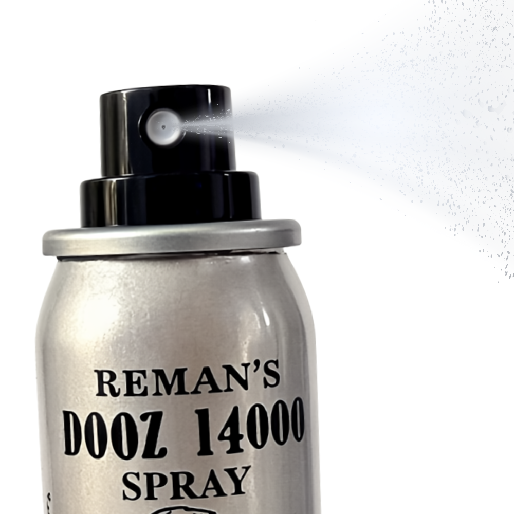 Reman’s Dooz 14000 delay spray bottle in silver with black nozzle spraying mist