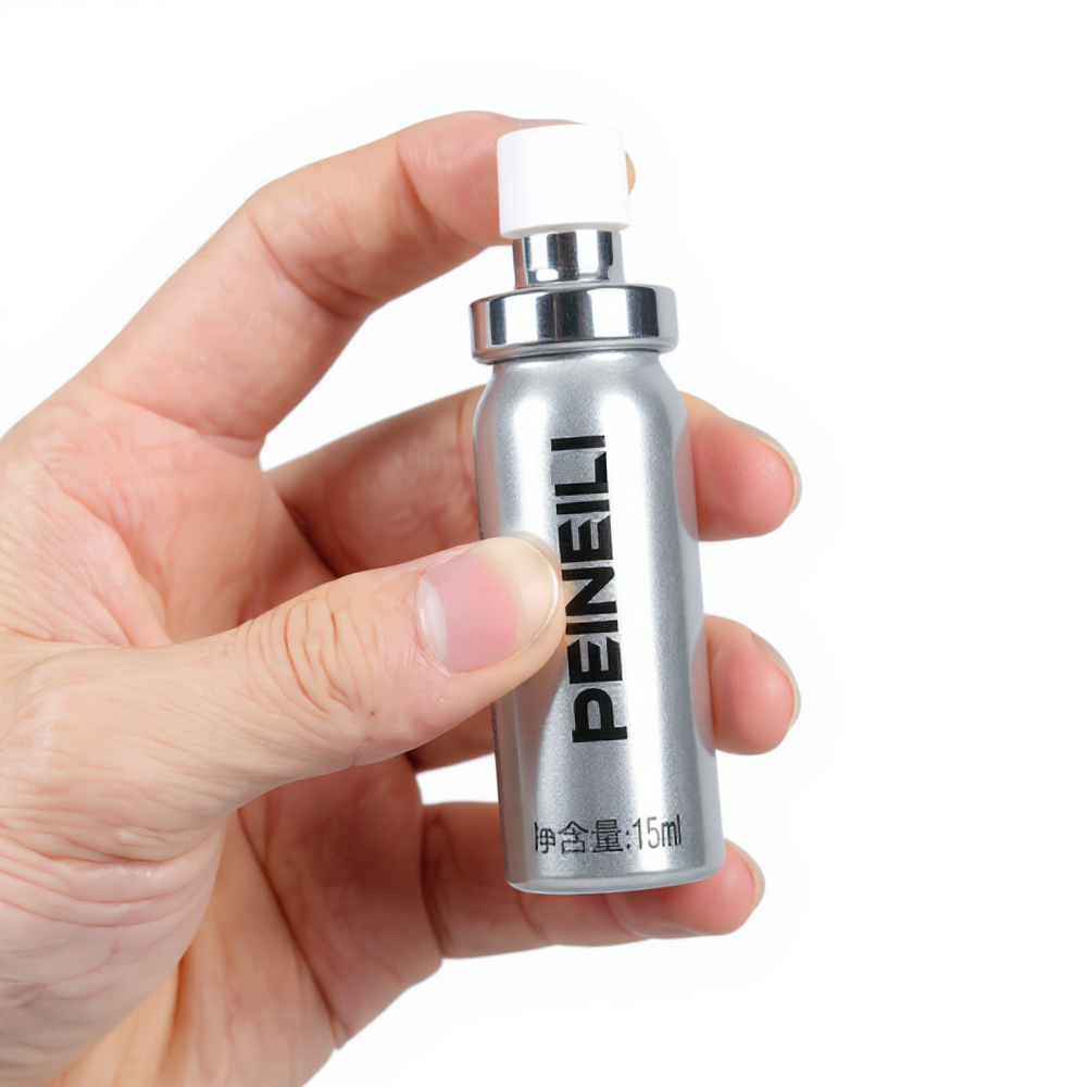 Hand holding Peineili delay spray 15ml can, numbing spray for men to delay ejaculation and improve control