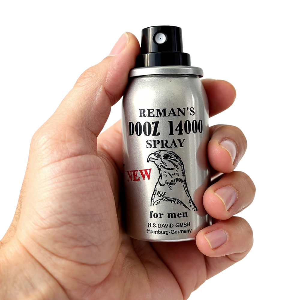 Hand holding Reman’s Dooz 14000 Delay Spray for men, silver bottle with black spray nozzle and falcon logo