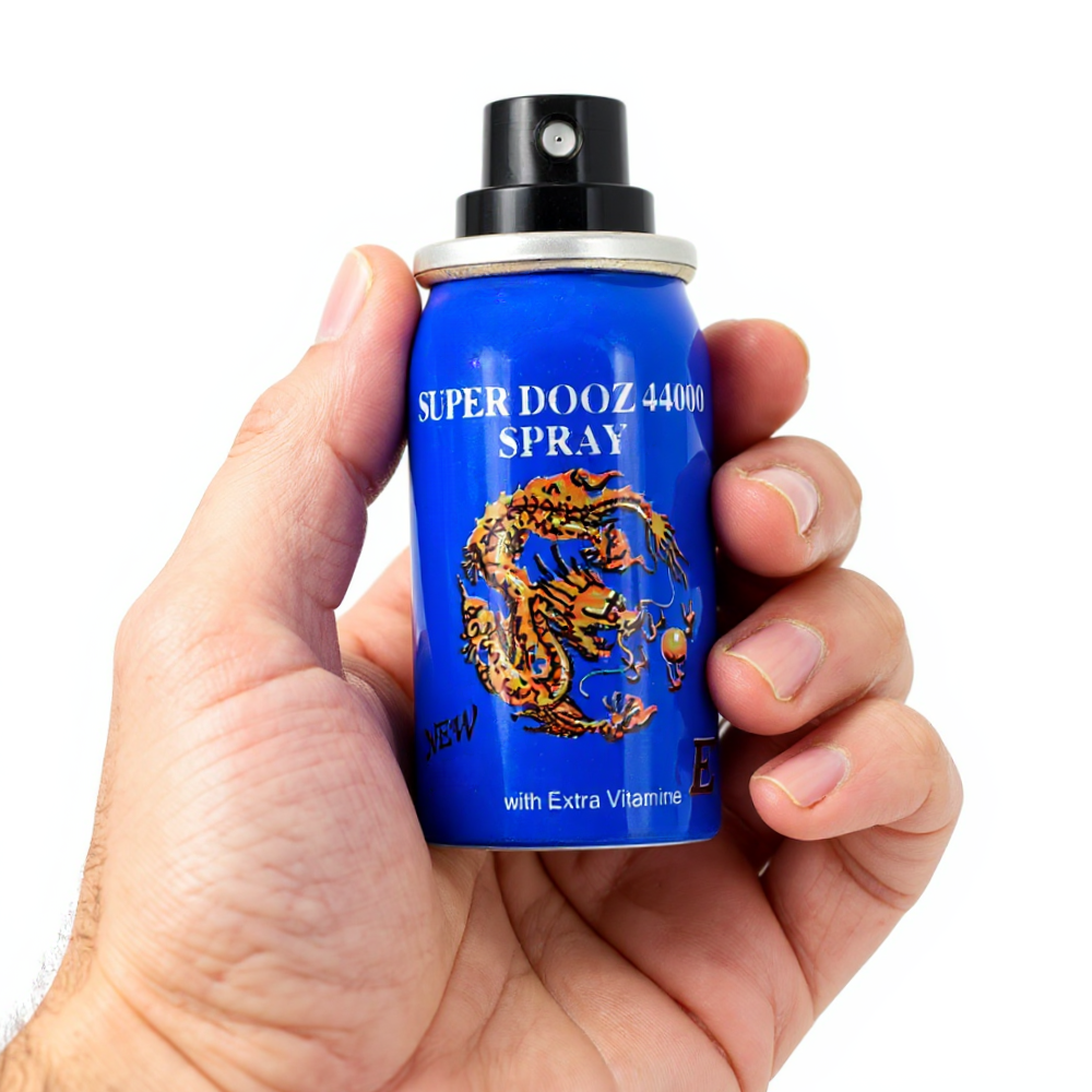 Super Dooz 44000 Delay Spray with Extra Vitamin E, blue bottle held in hand