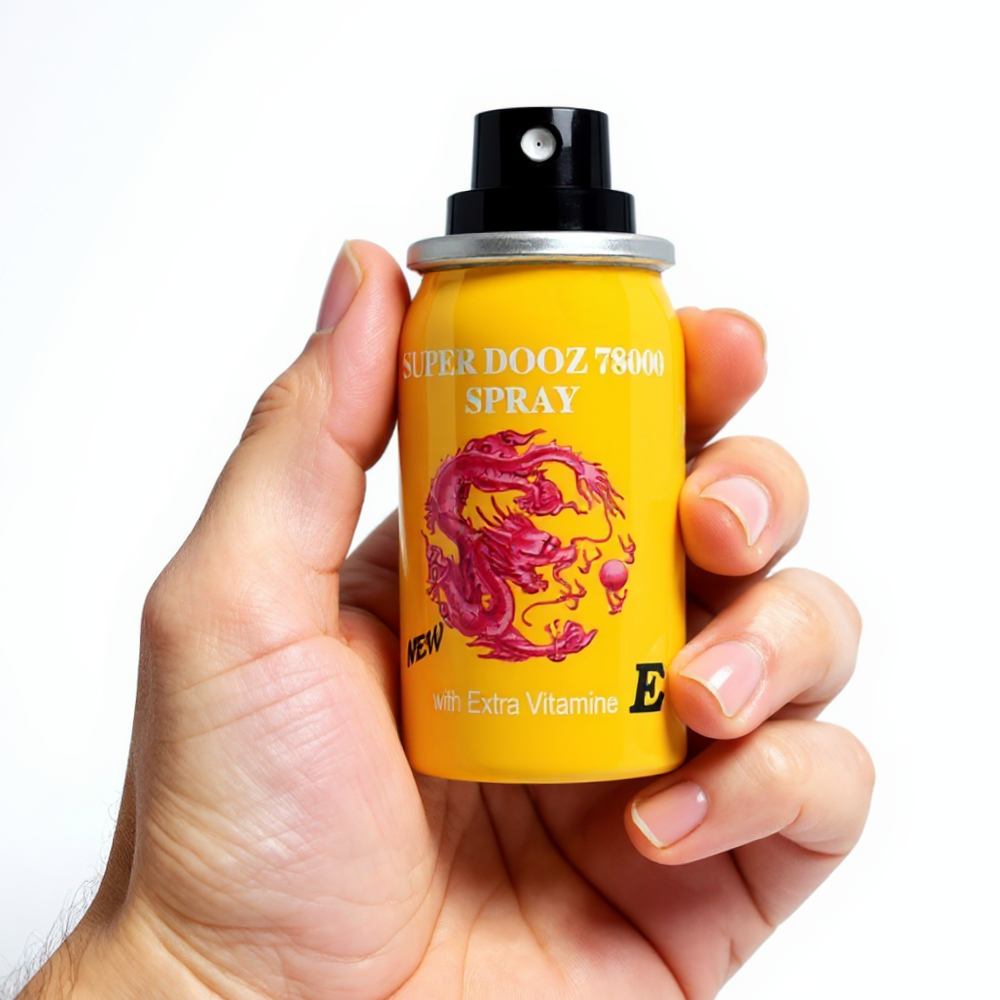 Super Dooz 78000 Delay Spray with Extra Vitamin E, yellow bottle held in hand