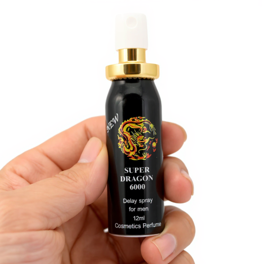Hand holding Super Dragon 6000 Delay Spray for men, black bottle with gold cap and dragon logo